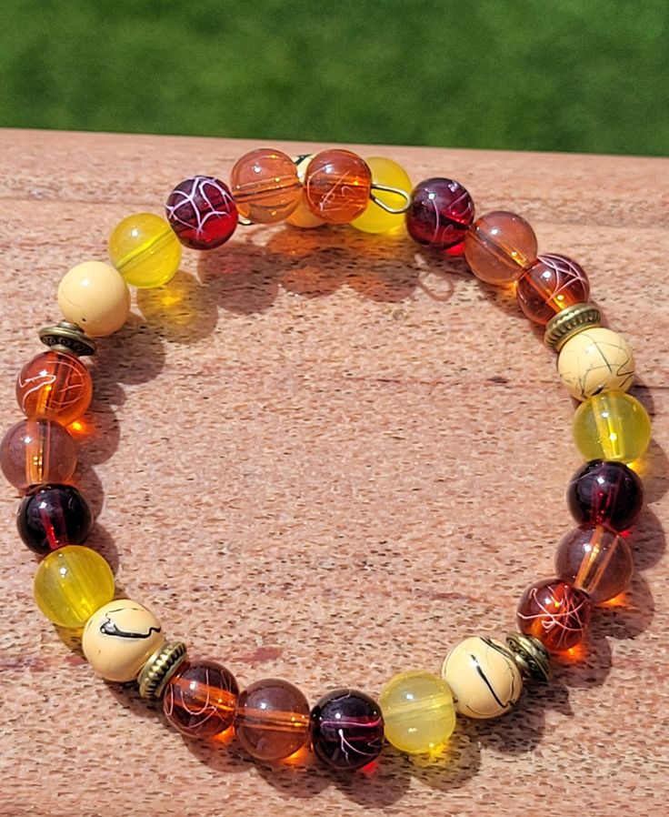 Beautiful Autum colors of glass beads on brass memory wire, brass spacers. Charmless. Spiritual Amber Beaded Bracelets, Bohemian Czech Glass Stretch Bracelet With Colorful Beads, Bohemian Stretch Bracelet With Colorful Czech Glass Beads, Yellow Czech Glass Bracelets With Round Beads, Amber Beaded Bracelets With Natural Stones, Amber Hand-strung Round Beaded Bracelets, Amber Hand-strung Bracelets With Round Beads, Bohemian Amber Beaded Bracelets With Round Beads, Bohemian Czech Glass Stretch Bracelet With Spacer Beads