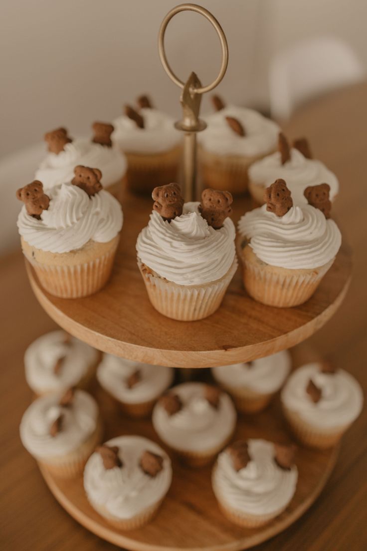 cupcakes and cookies on a three tiered tray