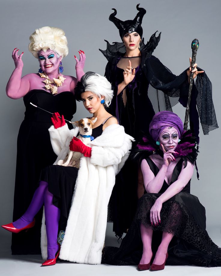 four women dressed in costumes posing for a photo