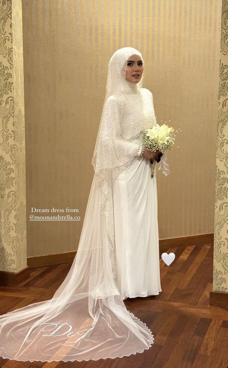 a woman in a white wedding dress holding a bouquet and standing on a hard wood floor