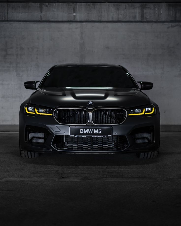 the front end of a black bmw car