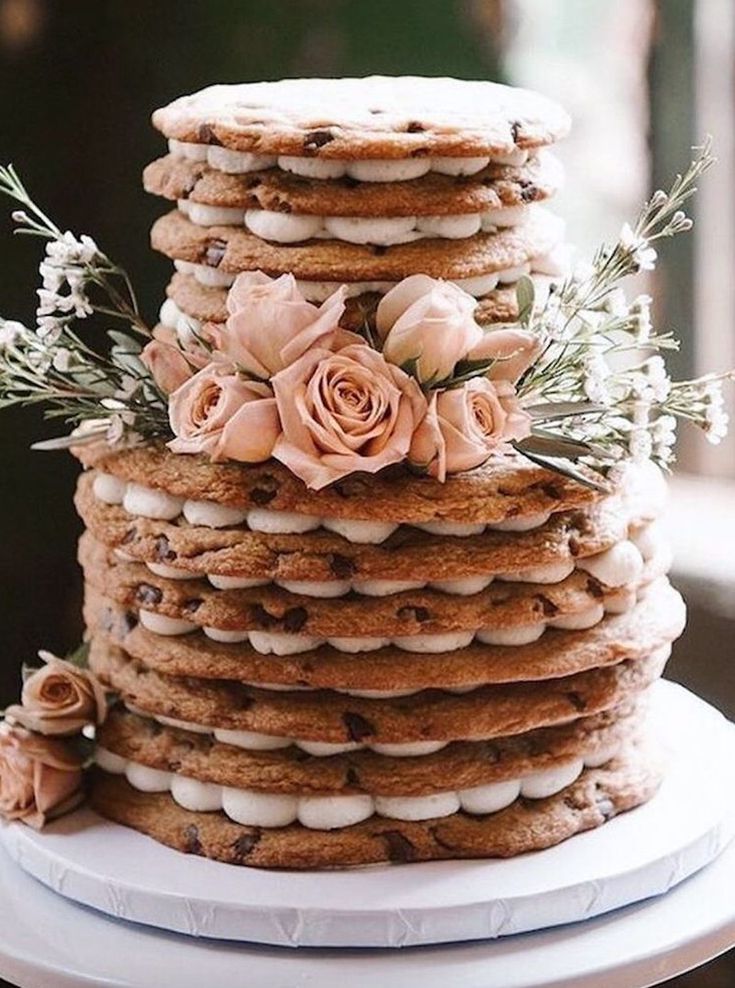 a tall stack of cookies with flowers on top