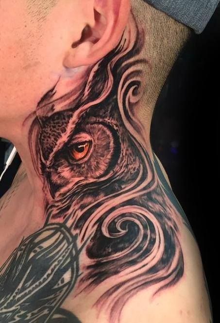 a man with an owl tattoo on his neck