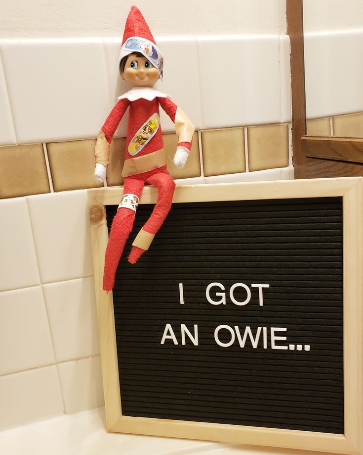 an elf sitting on top of a sign that says i got an oviet