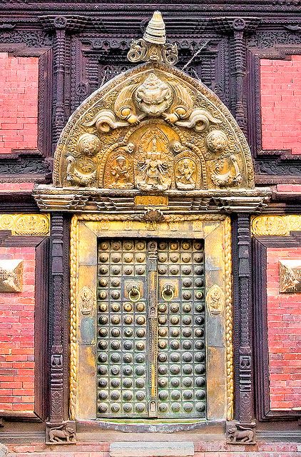 an ornate door on the side of a red brick building