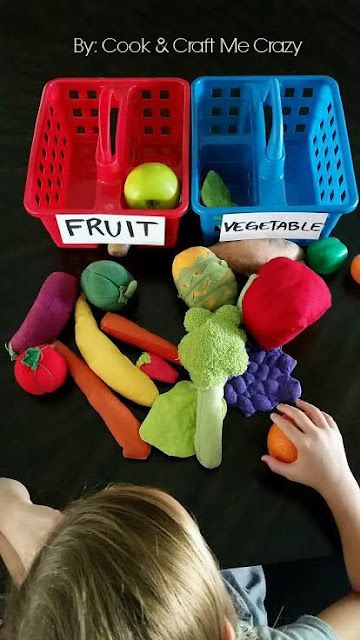 a little boy playing with fruits and vegetables