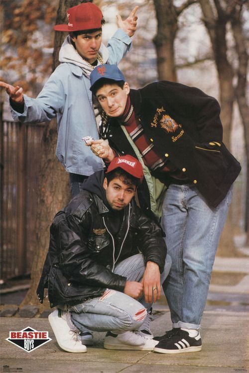 three young men posing for a photo in the street