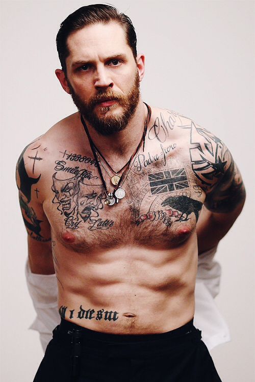 a shirtless man with tattoos on his chest