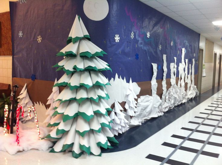 paper christmas trees are lined up on the floor