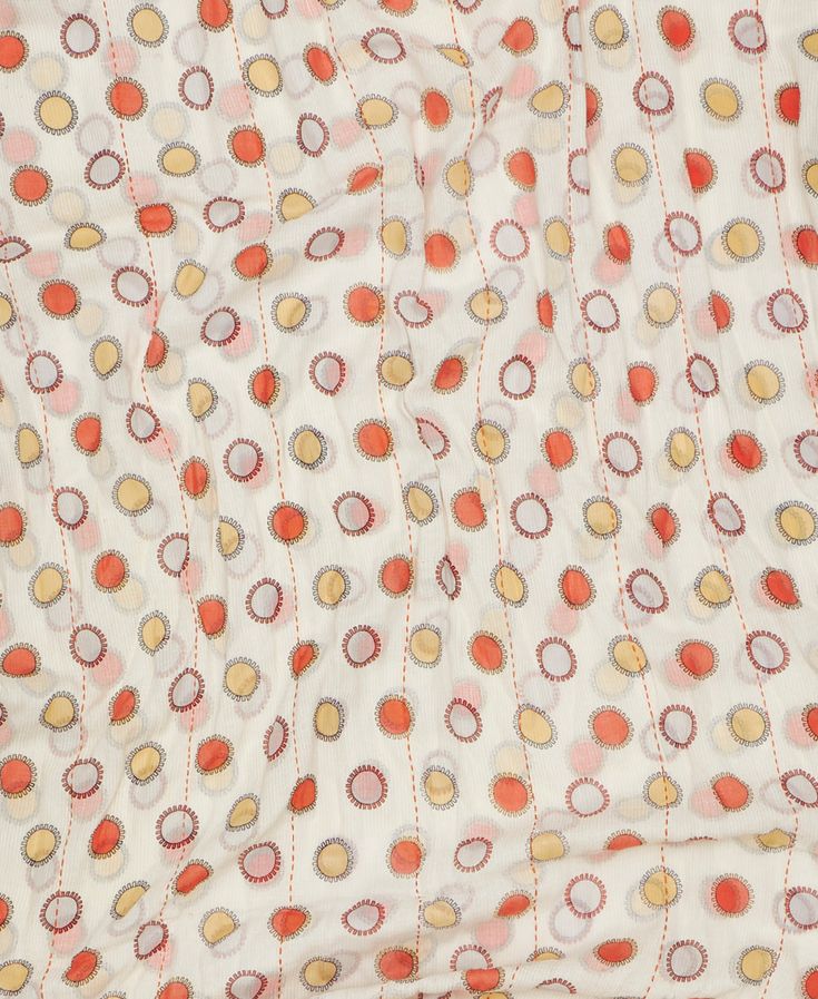 Introducing our vintage kantha scarf. Handcrafted from vintage saris with a beautiful coral and cream circle pattern, each lightweight cotton scarf is one-of-a-kind. Soft to the touch, this embroidered scarf is the perfect unique and eco-friendly accessory. Embrace the beauty of handmade this season. PRODUCT DETAILS: Size: 28" x 77" Materials: 2 Layers of Upcycled Vintage Cotton Saris Vintage sari material may contain beautiful small imperfections or patchwork. Thread color will vary. Care: Machine wash cold and hang dry. SKU# SS240127 Made by an artisan in Ajmer, India, this product is Fair Trade Verified and features a hand-stitched signature of the maker. Spring Red Cotton Dupatta, Red Cotton Dupatta For Spring, Spring Patterned Cotton Dupatta, Spring Cotton Patterned Dupatta, Spring Patterned Dupatta With Printed Motifs, Spring Festive Orange Dupatta, Spring Bohemian Saree, Sustainable Wardrobe, Eco Friendly Accessories