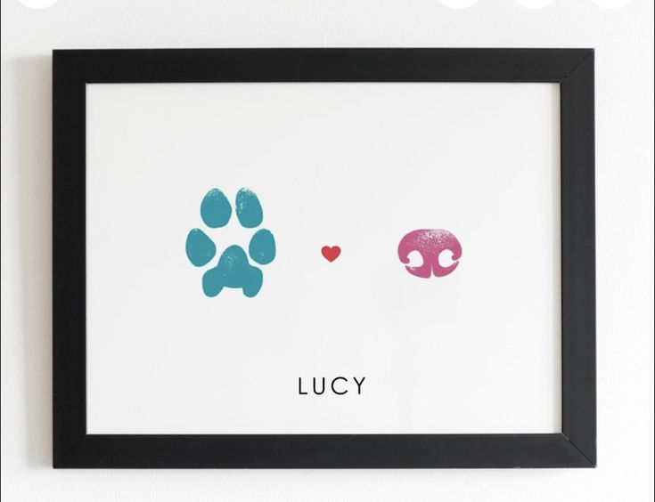 a dog paw print with the words lucky and a pink heart on it's left side