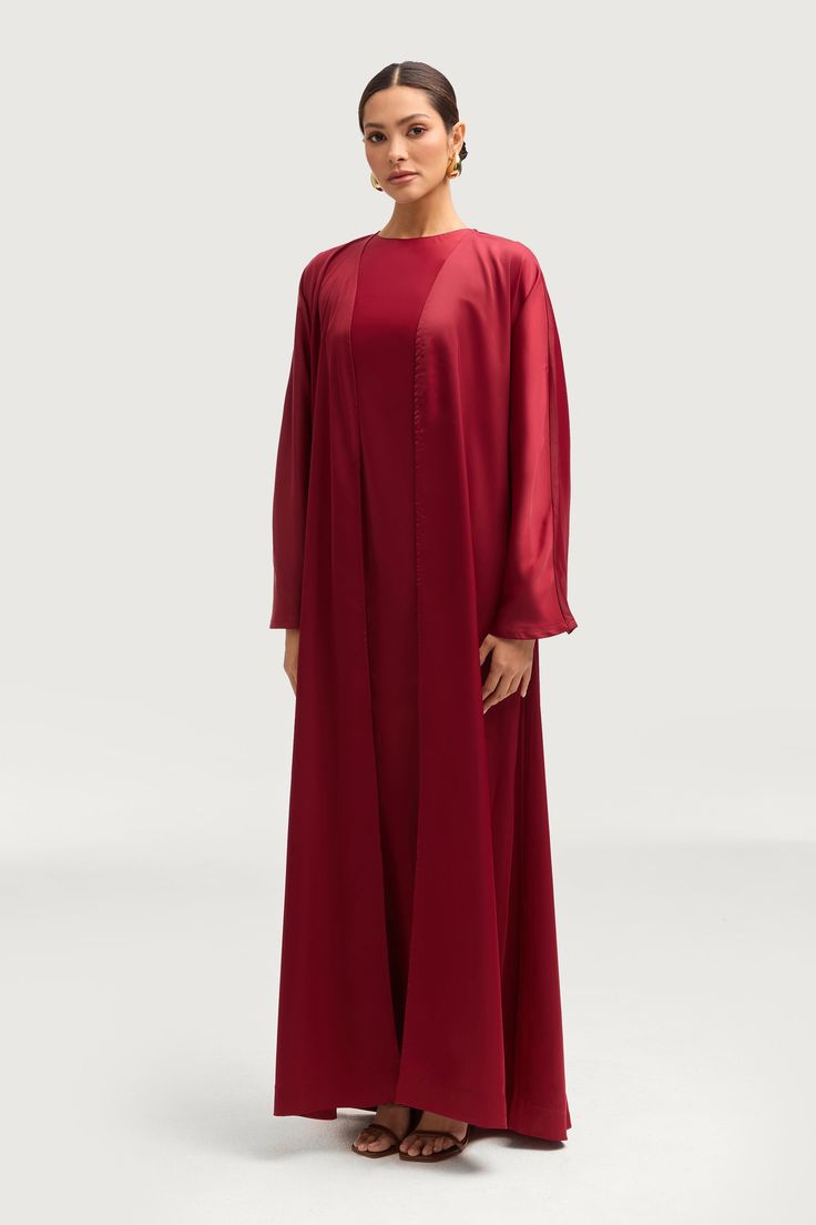 Elevate your wardrobe with the elegant Kamila Open Abaya in Maroon. A timeless classic, this staple piece features a stunning satin flare sleeve design that is both sophisticated and versatile. Exude an air of luxury and elegance with this must-have addition to your collection. Model is 5'7" and is wearing size XS/58". White Dress Formal, Nikkah Dress, Dresses Flowy, Open Abaya, Engagement Dresses, Dress Satin, Kids Outerwear, Basic Dress, Ribbed Dresses