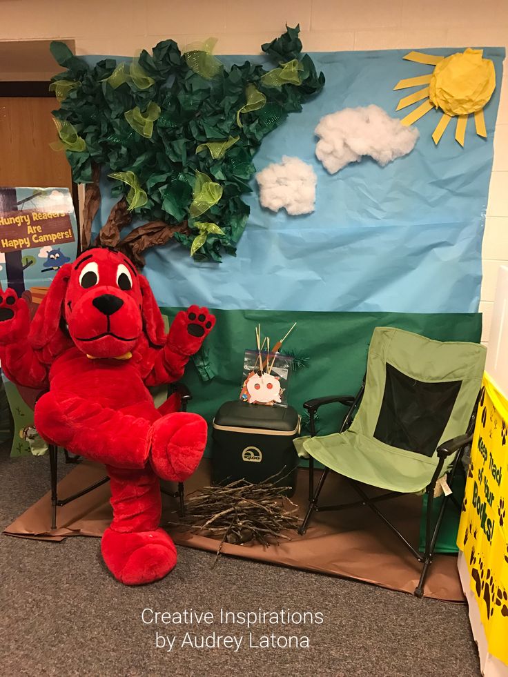 a large red dog sitting on top of a chair in front of a bulletin board