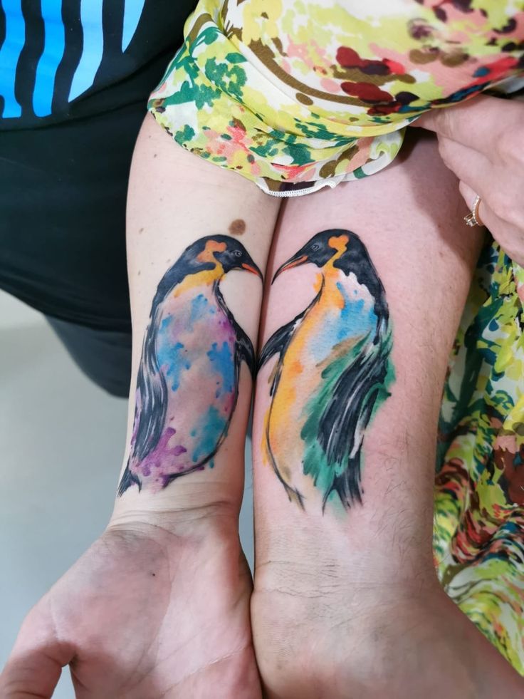 two people with matching tattoos on their arms