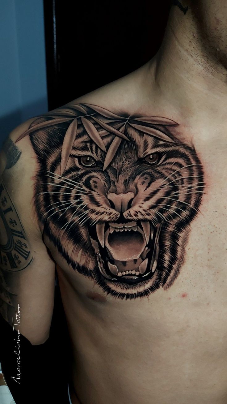 a man's chest with an angry tiger tattoo on his chest and the head of a tiger