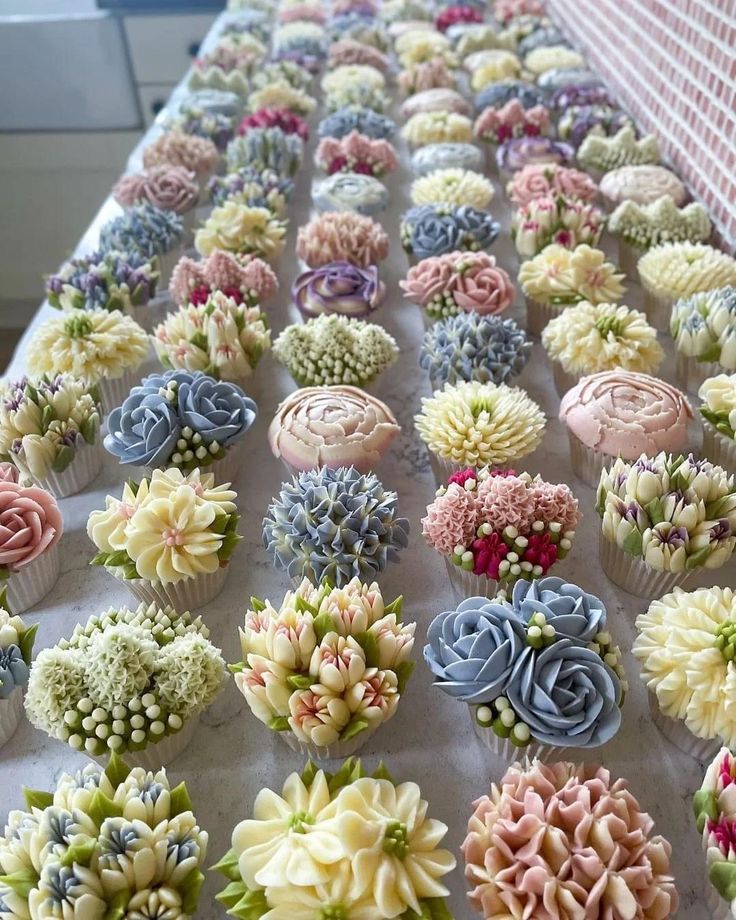 cupcakes decorated with flowers are sitting on a table