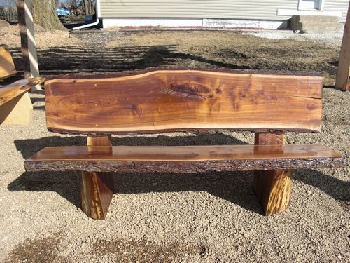 a wooden bench sitting on top of a gravel field