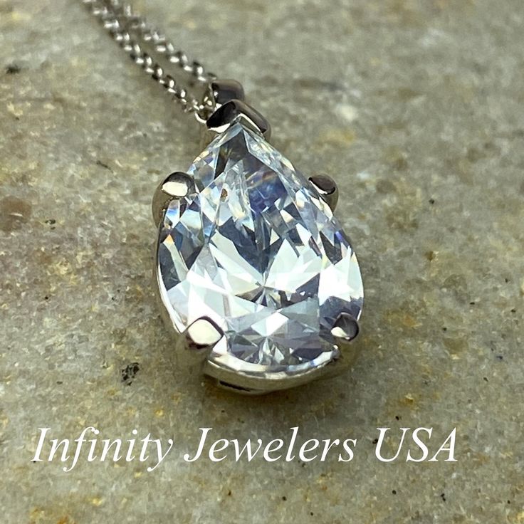 "The pendant pictured is a simulated diamond #6998 Also available with moissanite - please message us for pricing. -Approximate total carat weight: approx. 3.60ctw diamond equivalent -Center Stone Size: 12x8mm - approx. 3.60ct diamond equivalent -Center Stone Shape: pear / tear drop -Gem Type: simulated diamond -Stone Clarity: VVS1 -Stone Color: D -Moh's Scale: 8.5 hardness -Metal Type and Purity: 14k white gold -Setting: 5 prong basket head -Chain: delicate 14k gold chain / heavier option with Formal Diamond Solitaire Necklace With Teardrop Pendant, Dazzling Pear-shaped Necklace For Anniversary, Classic Drop Necklace With Brilliant Cut Cubic Zirconia, Classic Cubic Zirconia Drop Necklace With Brilliant Cut, Classic Brilliant Cut Cubic Zirconia Drop Necklace, Silver Drop Solitaire Necklace For Formal Occasions, Classic Pear-shaped Cubic Zirconia Diamond Necklace, Formal Silver Drop Solitaire Necklace, Oval Drop Necklace For Anniversary