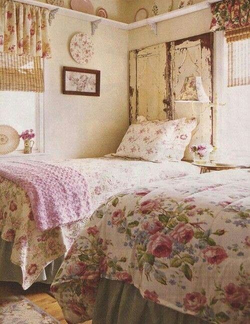 an old fashioned bedroom with floral bedspread and pillows