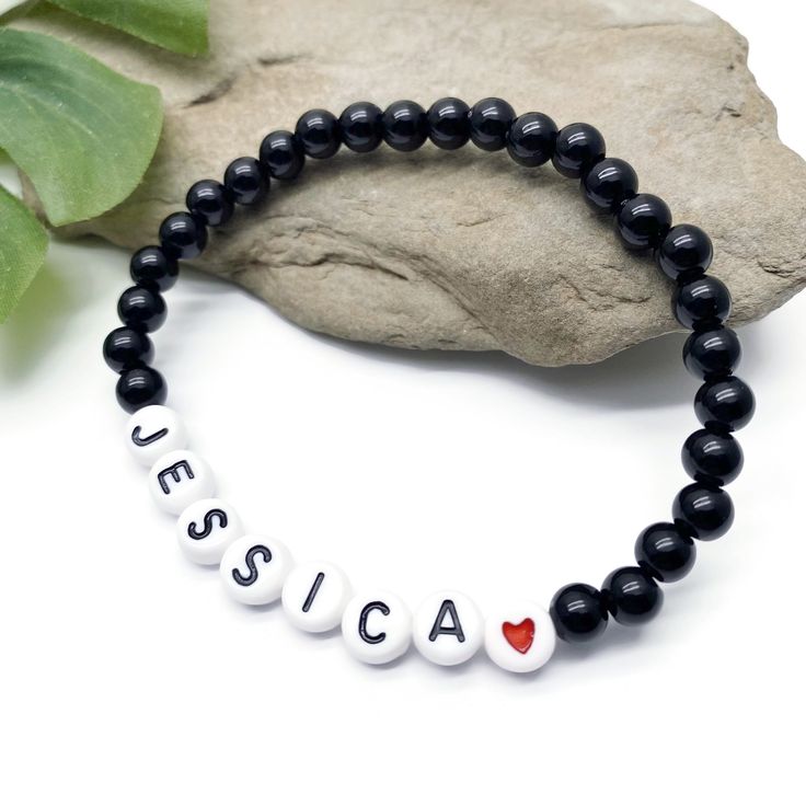 A super cute black acrylic name bracelet with your choice of wording and size! Personalise it with your name, your child's name, an inspirational word, your team name, a pet name, a nickname, or anything else you can think of eg Best Nanny, Bridesmaid, or an anniversary date or birth date.The custom made bracelet has 6mm acrylic beads and flat white acrylic letter beads, which are 7mm diameter. It is thread on strong elastic and will stretch a little bit so you can roll it onto your wrist gently Personalized Black Jewelry With Name, Personalized Black Name Jewelry, Black Beaded Bracelet With Letter Print As Gift, Black Beaded Bracelets With Letter Print As Gift, Customized Black Jewelry For Personalized Gift, Personalized Black Beaded Bracelets, Adjustable, Personalized Adjustable Black Bracelets, Personalized Black Bracelet, Casual Black Stretch Bracelet With Letter Beads