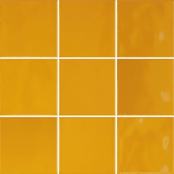 a yellow tiled wall with white squares on it