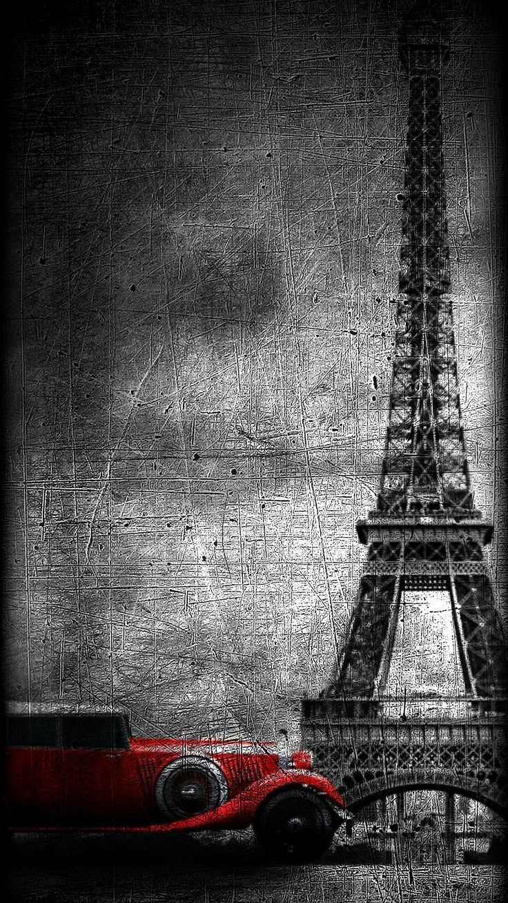 a red car parked in front of the eiffel tower