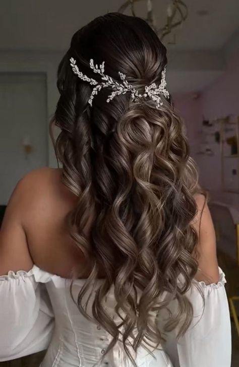 a woman with long hair wearing a tiara