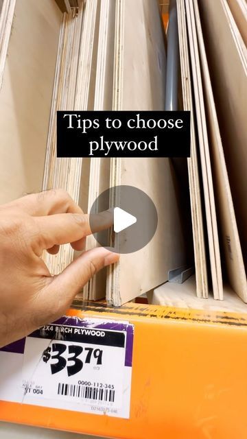 a person is picking up some plywood from a shelf in a store with the text tips to choose plywood