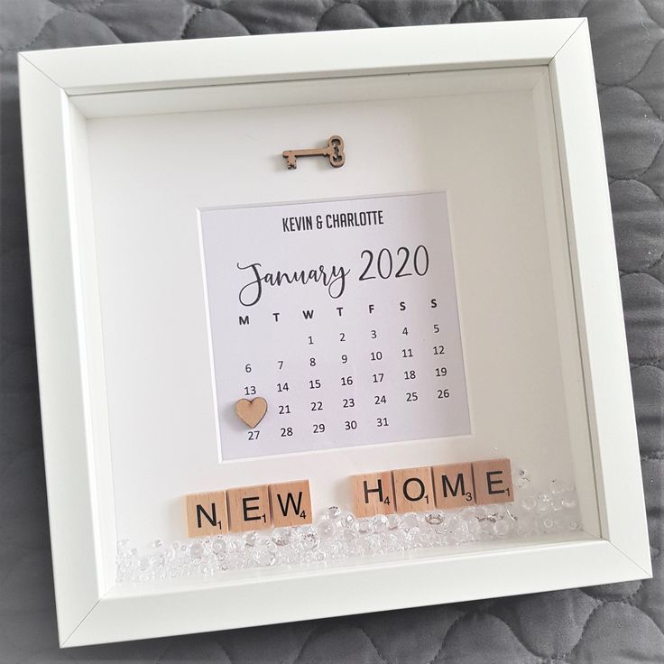 a white frame with scrabble letters and a calendar