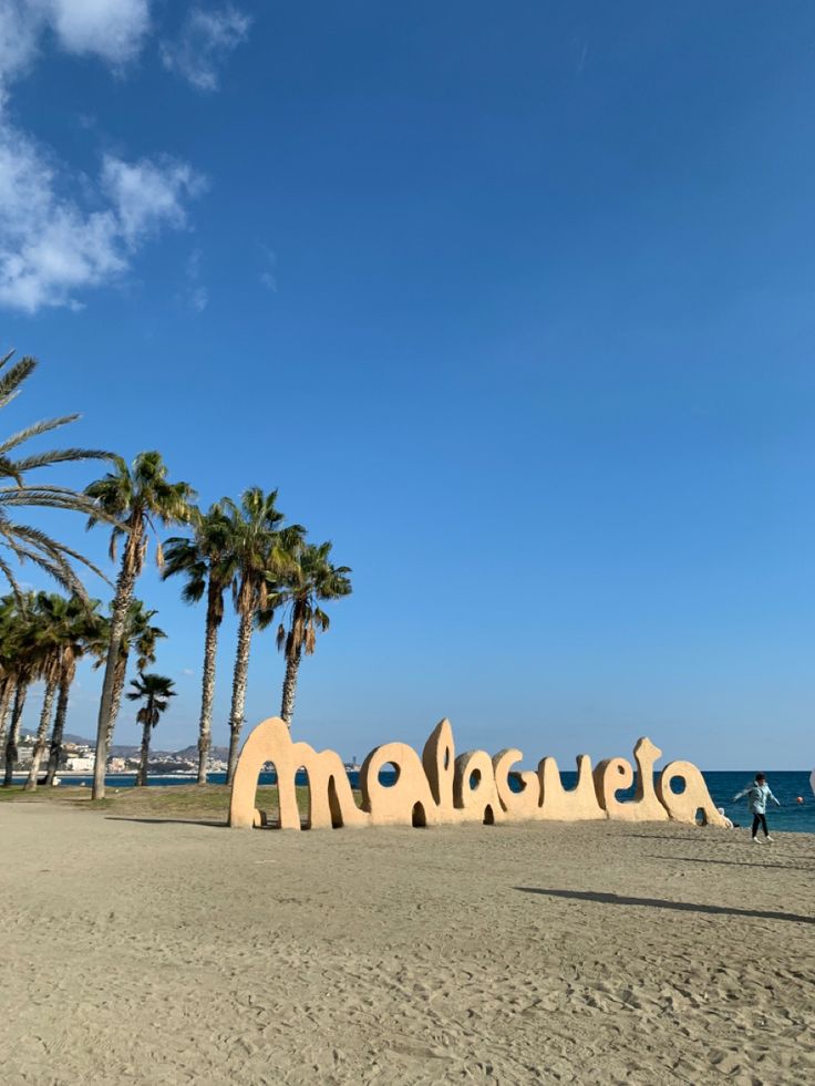 a beach with palm trees and the word makaua written in large letters on it