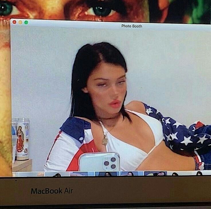 a woman with an american flag bandana on her arm looking at a cell phone