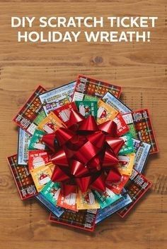 a large red bow on top of a pile of candy wrapped in paper and tied with ribbon