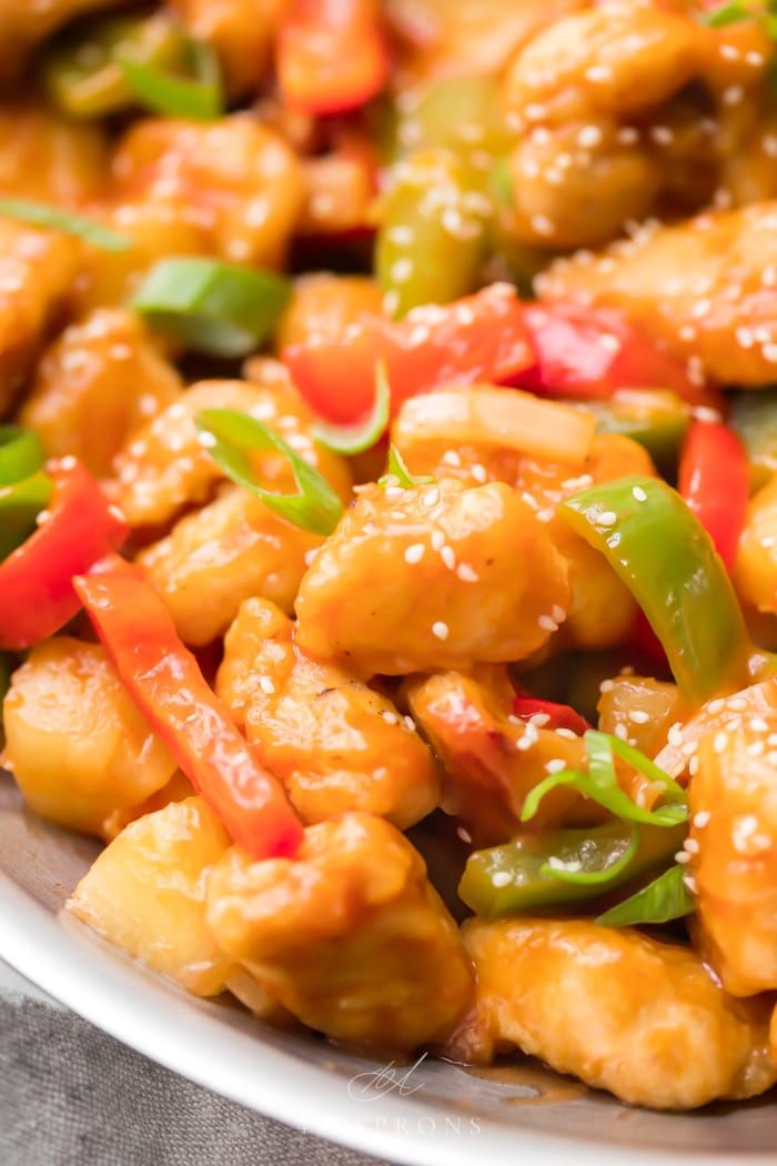 chicken with peppers and sesame seeds in a white bowl