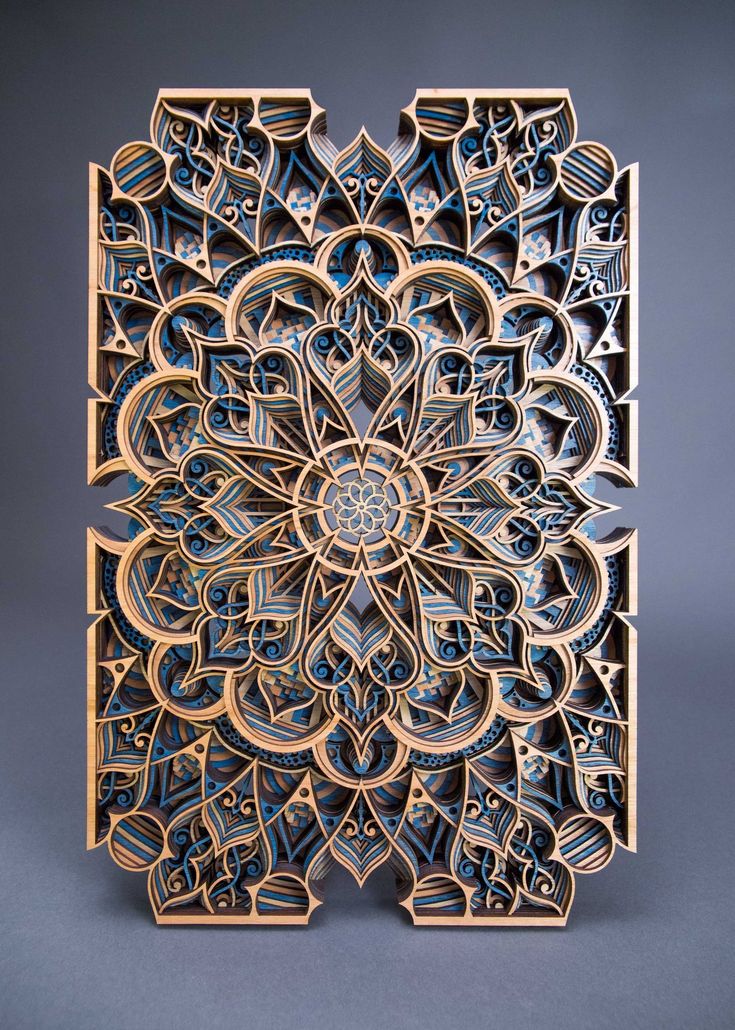 an intricately designed wooden block with blue and white designs