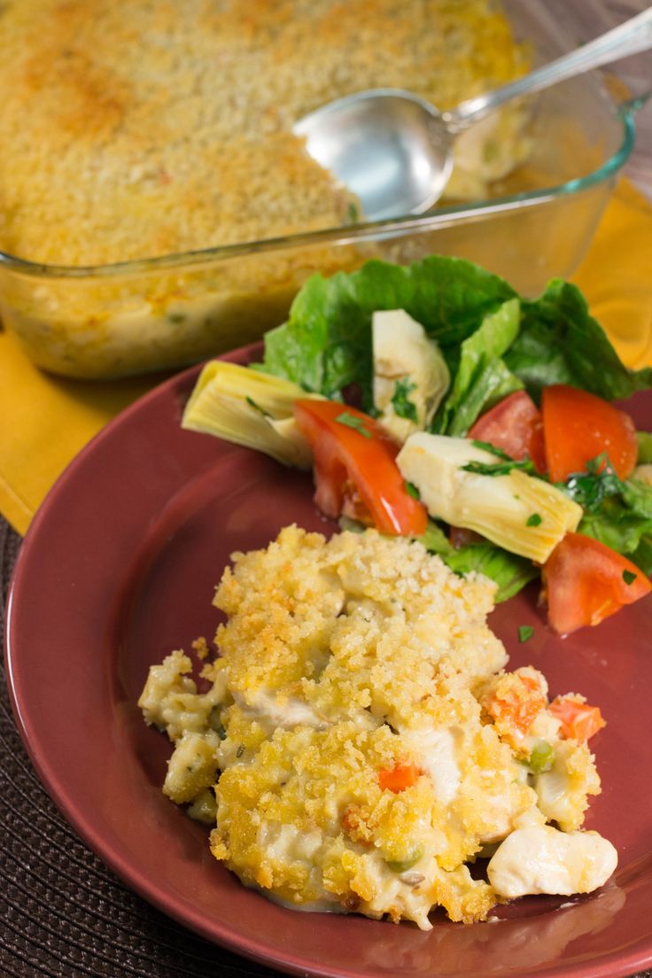 a red plate topped with food next to a casserole dish