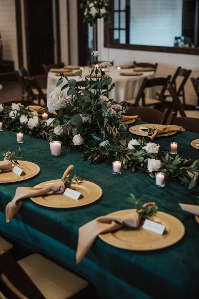 the table is set with plates and place settings for guests to sit down at it