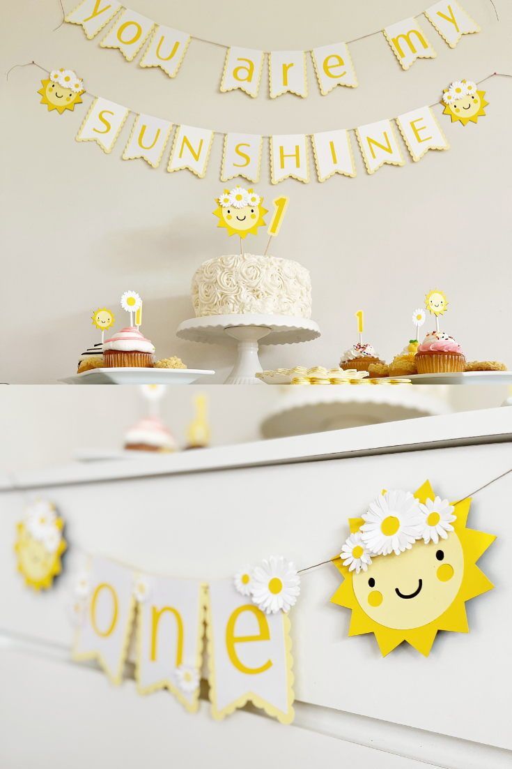 a cake and cupcakes on a table with bunting banner in the background