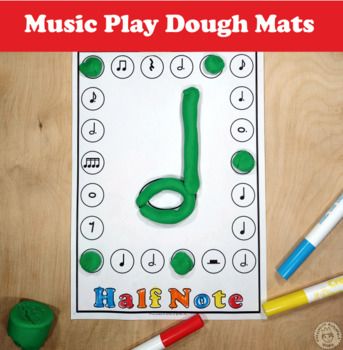 a music play dough mat with markers and crayons on the table next to it