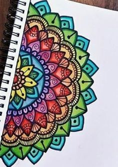 a spiral notebook with an intricate design on it