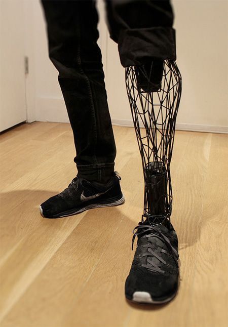 a person standing on top of a hard wood floor next to a white wall and black shoes