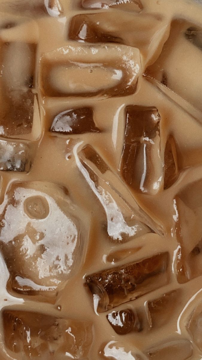 some ice cubes are sitting on top of brown liquid