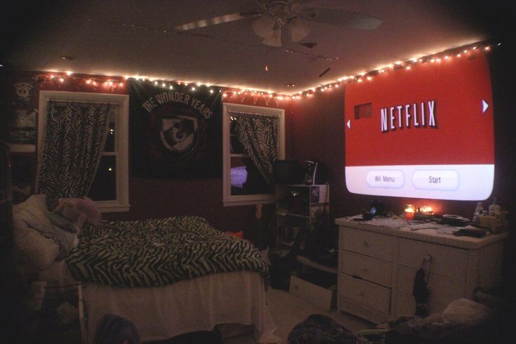 a bedroom with red lights on the ceiling and a netflix sign above the bed that says netflix