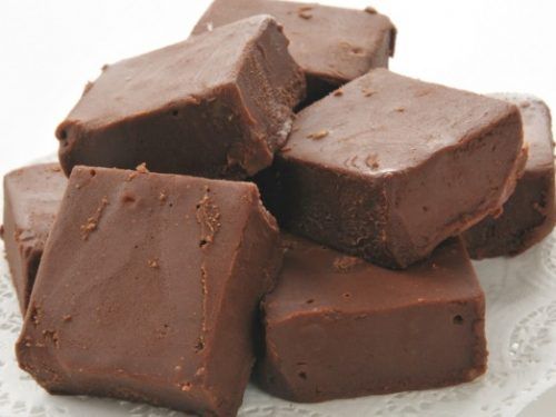 several pieces of chocolate sitting on top of a white plate