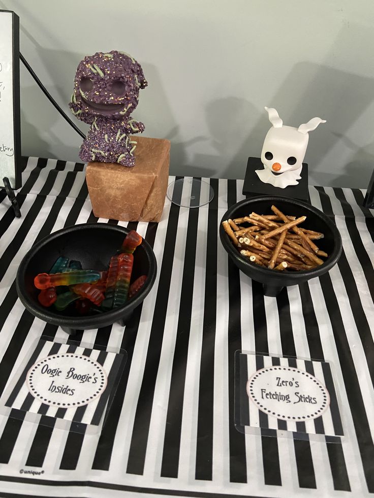 the table is set up with black and white striped cloth, paper bags, scissors and other items