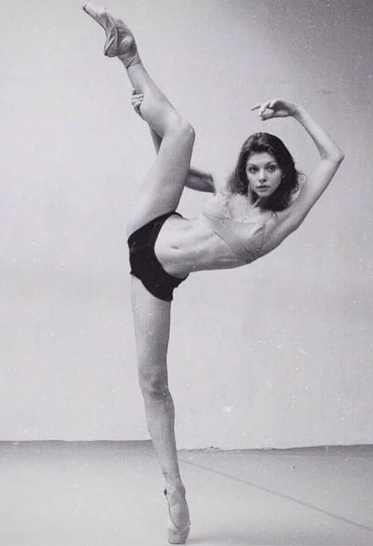 a woman in a leotard doing a dance pose