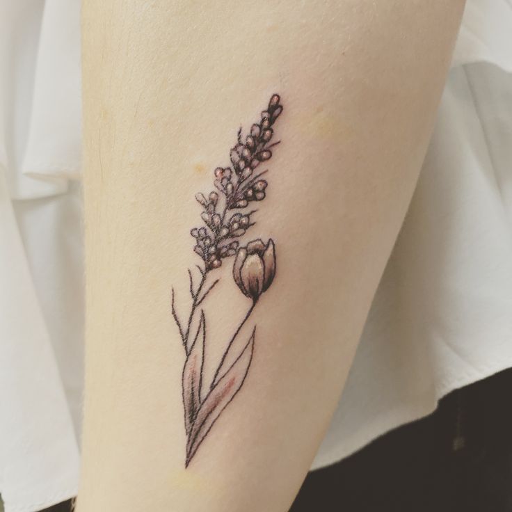 a small flower tattoo on the leg