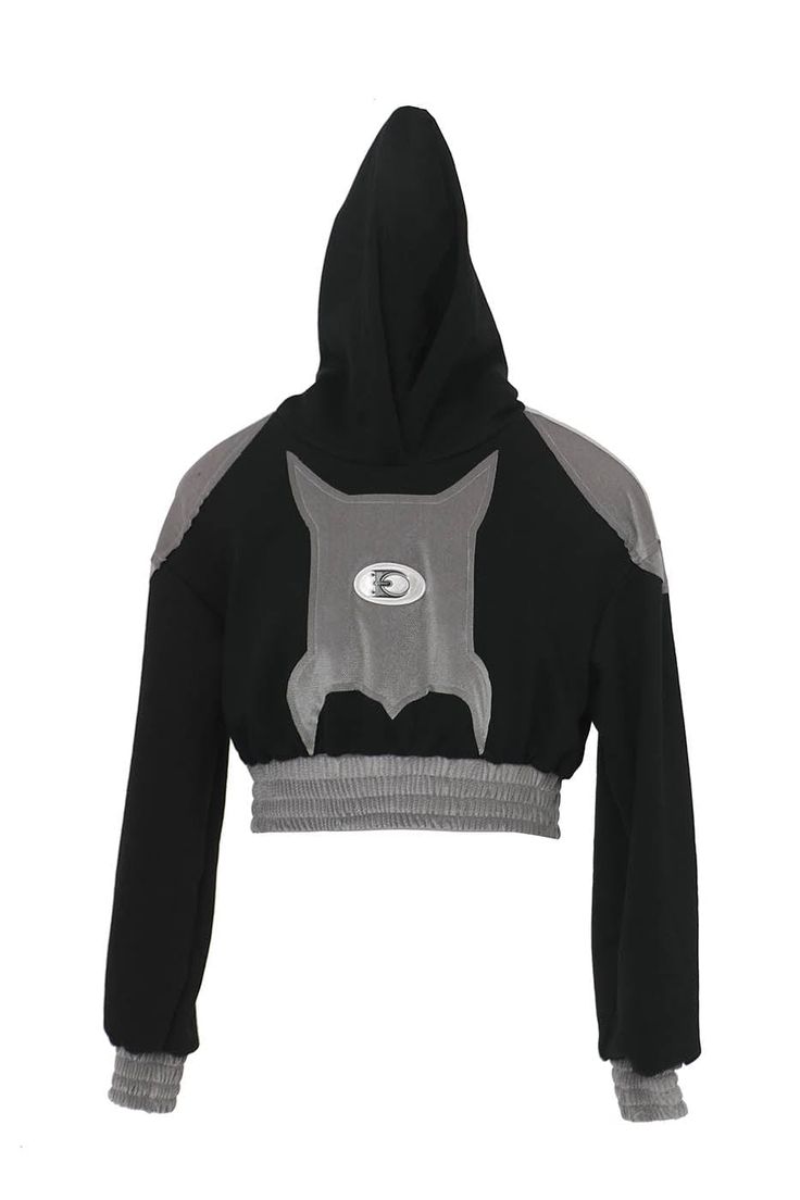 The Bat Patchwork Cropped Hoodie stands at the intersection of casual comfort and avant-garde style. This piece features a distinctive patchwork design on the front that resembles a bat, setting a bold and playful tone. Central to the hoodie is the brand's logo, anchoring the design with a sense of identity. The shoulders are enhanced with fabric that mimics the look of armor plating, adding an edge of sophistication and strength to the overall silhouette. The hoodie is designed with tightened h Trendy Black Hoodie With Patchwork, Trendy Black Patchwork Hoodie, Black Urban Hoodie With Patchwork, Urban Black Patchwork Hoodie, Hooded Patchwork Sweatshirt For Streetwear, Urban Patchwork Hoodie For Streetwear, Sporty Patchwork Hooded Hoodie, Sporty Hooded Patchwork Tops, Hooded Black Sweatshirt With Patchwork