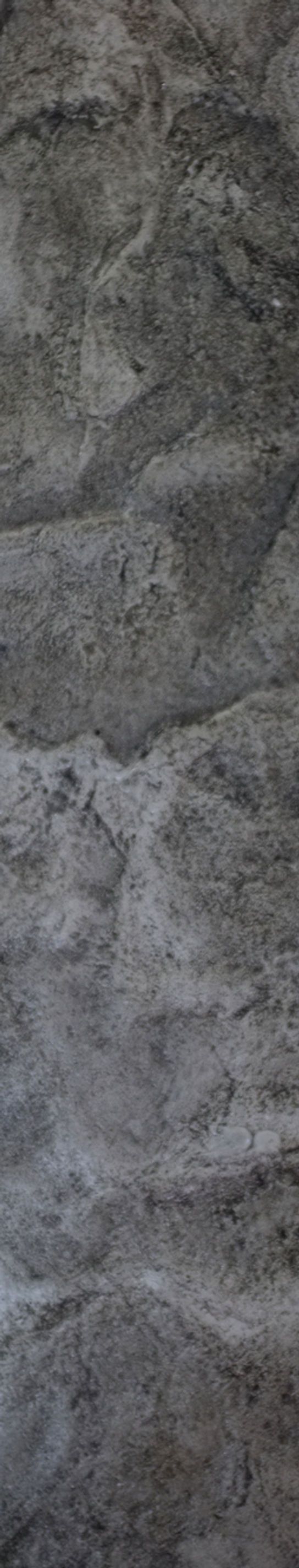 a man riding a skateboard on top of a stone wall