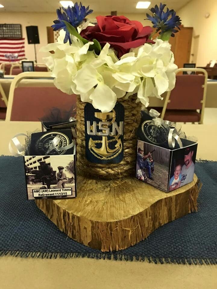 a vase filled with flowers sitting on top of a wooden table next to pictures and cards