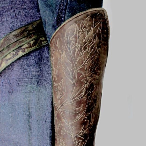 a cowboy's boots and jeans are shown in close up view, with the belt undone